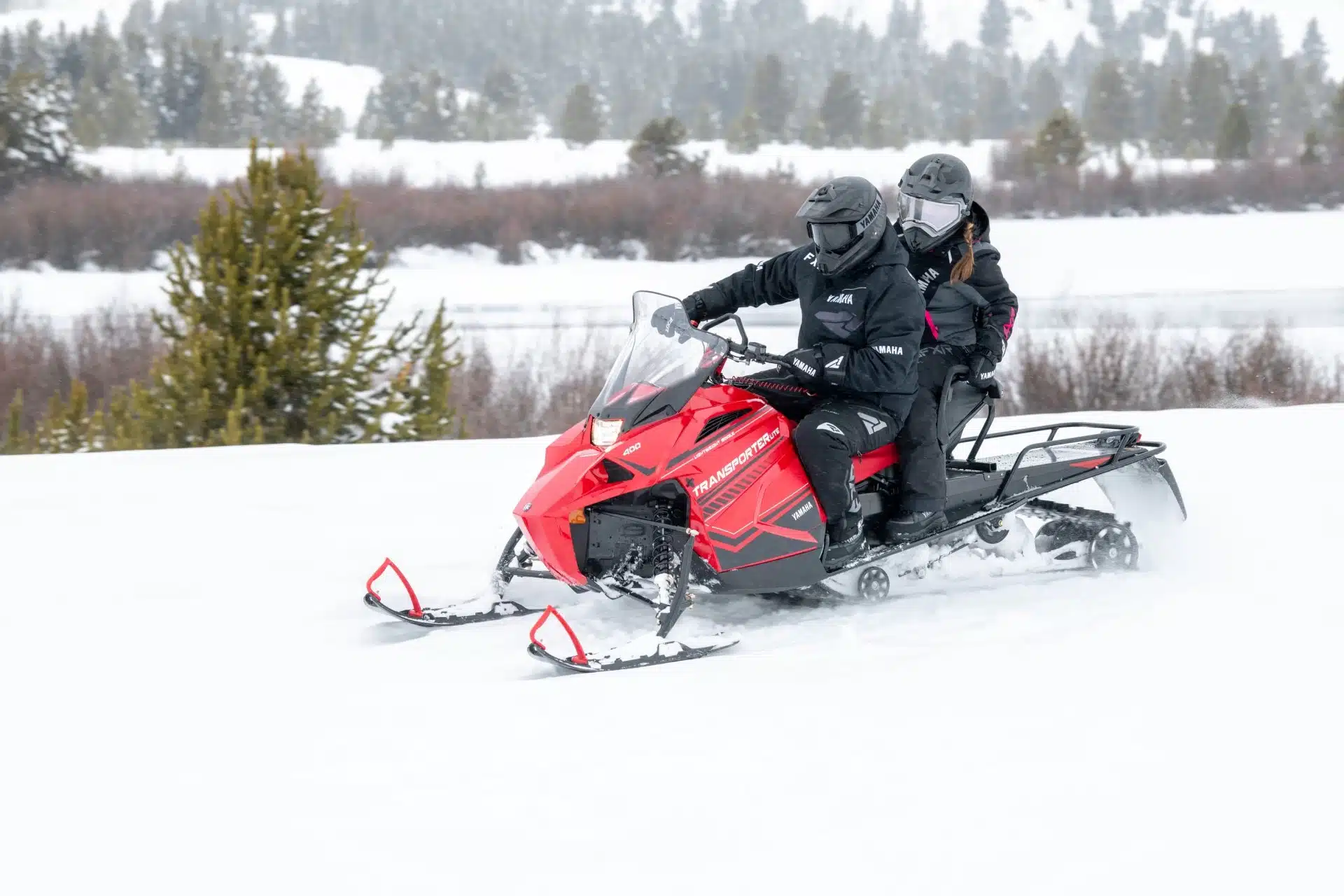 Snowmobile riders in deep snow